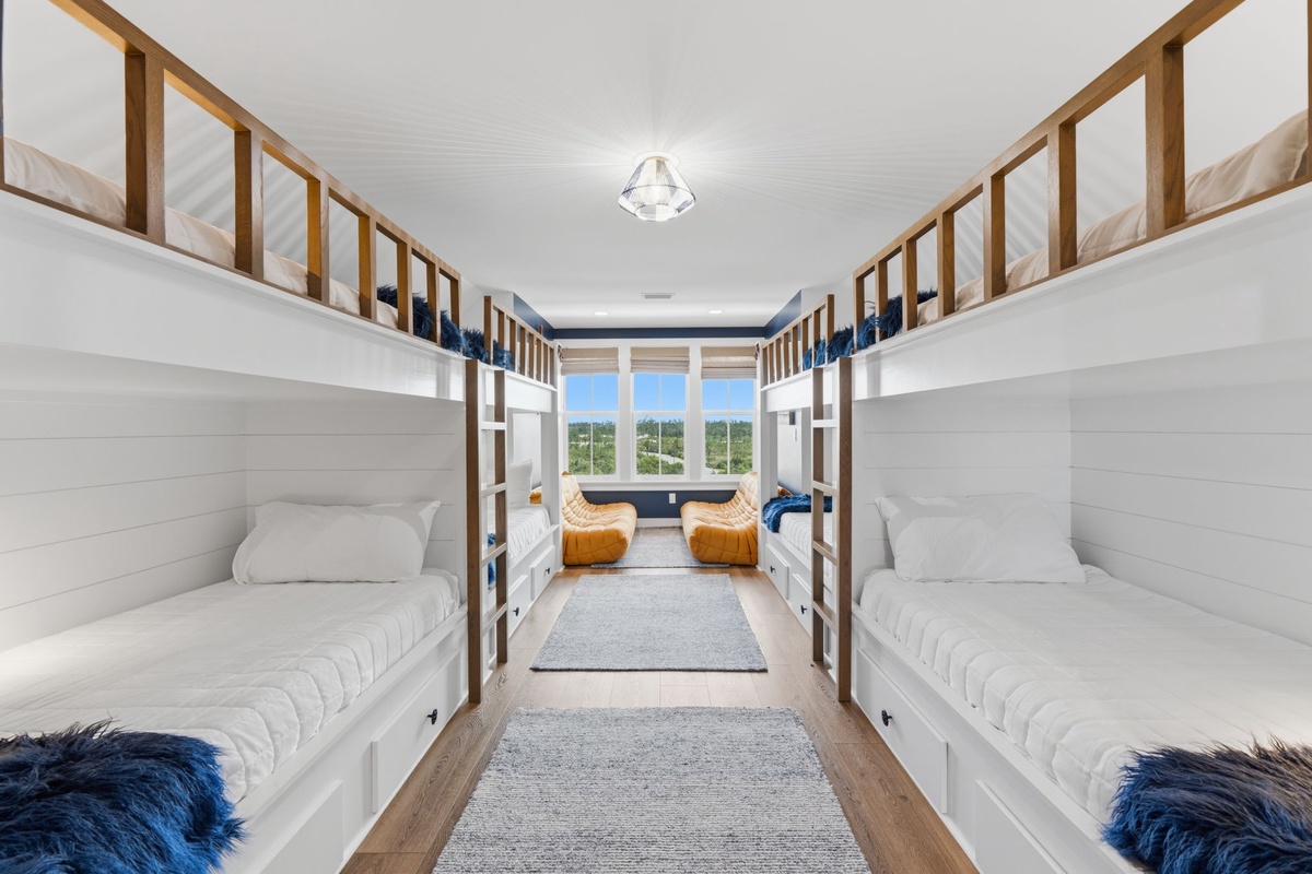 Four custom bunk beds create a cozy retreat where your group can rest and recharge together. Natural light floods the space through large windows, while plush seating offers a comfortable spot to relax and share stories.