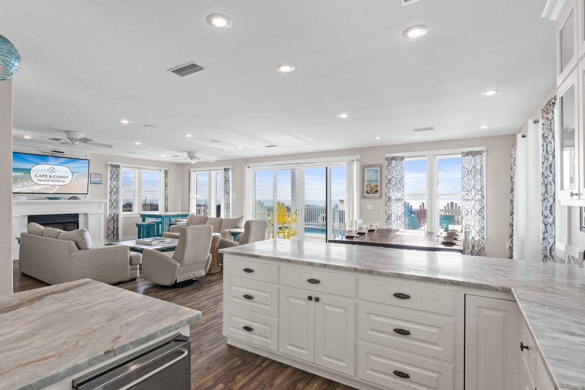 Your spacious kitchen island opens to a bright living area with stunning ocean views through floor-to-ceiling windows.