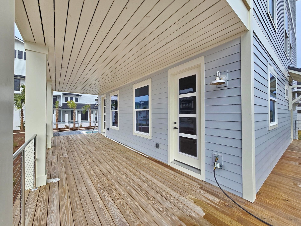 Your private covered deck offers warm wood flooring and peaceful views of the surrounding community.