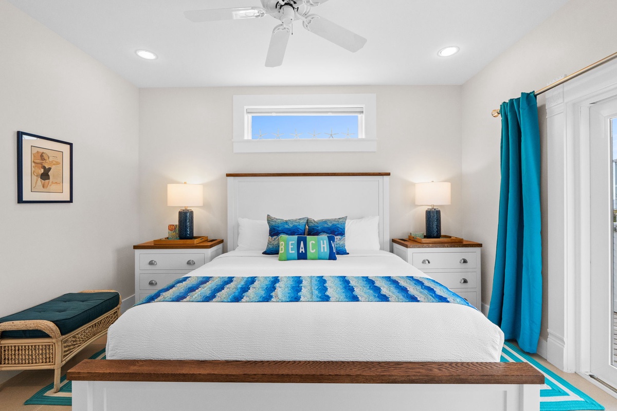 Slip into crisp white linens adorned with ocean-blue accents in your serene bedroom sanctuary, where coastal charm meets modern comfort.