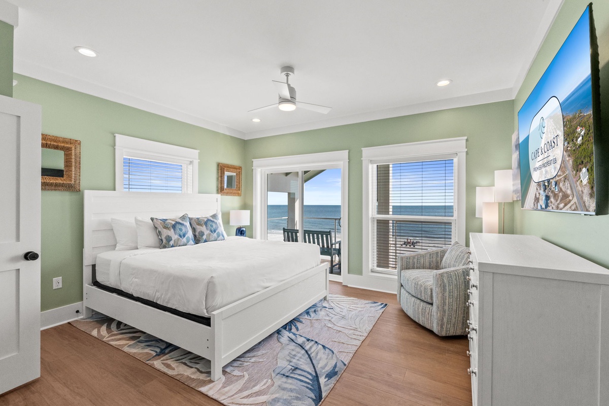Wake to stunning sea views from your coastal retreat. Soft sage tones and white linens create a peaceful escape, while glass doors open to your private balcony where the ocean awaits just steps away.