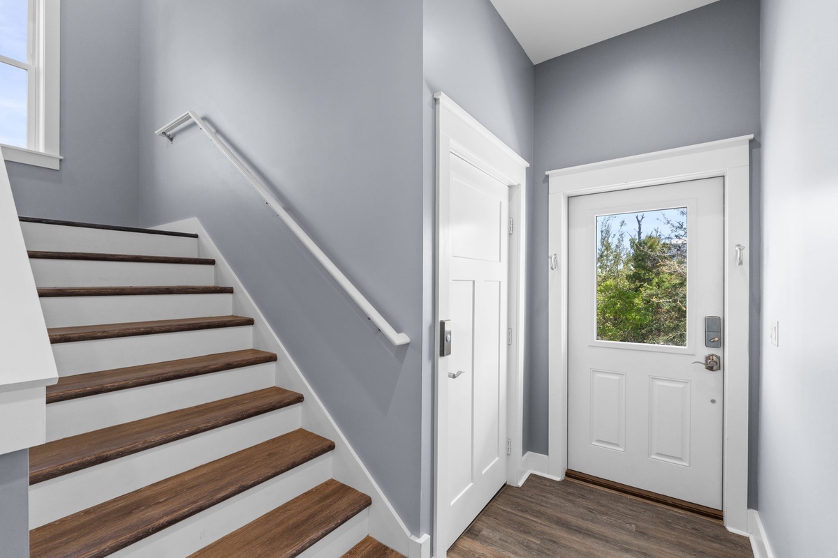 Step into your welcoming entryway with gleaming wood floors and fresh modern finishes that set the tone for your stay.