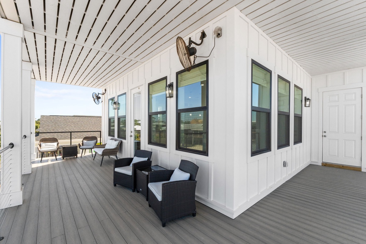Your spacious covered deck offers the perfect spot to unwind with morning coffee or evening cocktails in comfortable seating areas.