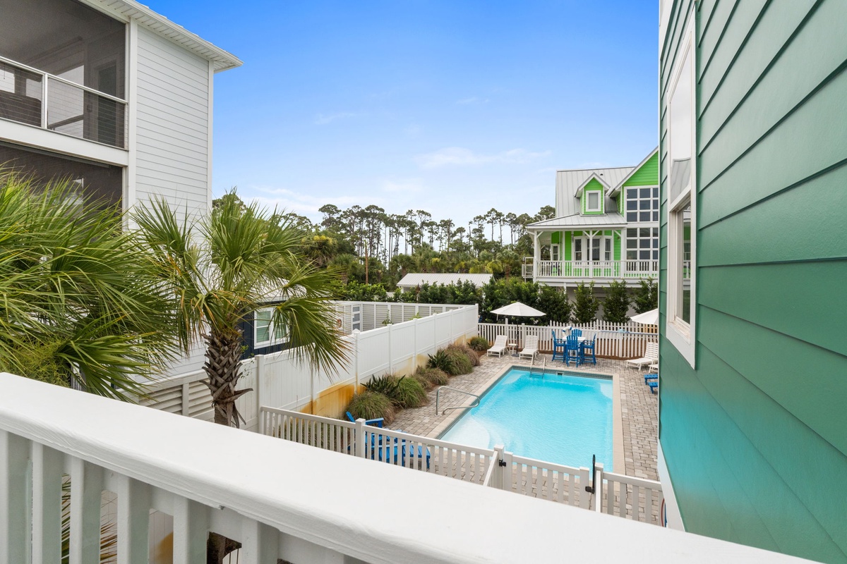 Overlook the inviting pool area from your balcony, surrounded by coastal charm and lush palms. Picture your days relaxing in this private oasis under the Florida sunshine.