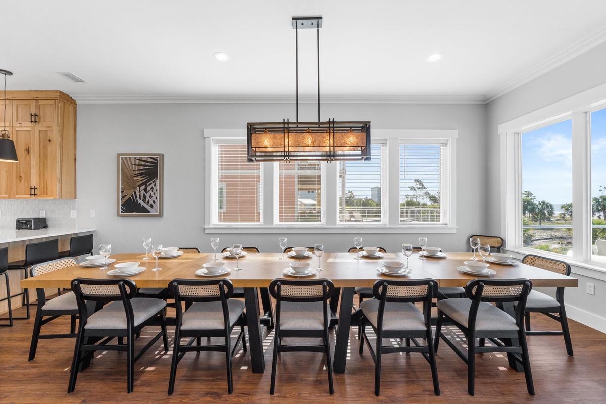 Gather your group around this stunning dining table where memorable meals await, bathed in natural light from panoramic windows.