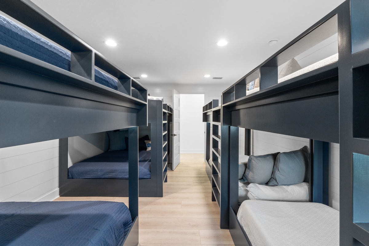 Your modern bunk room features custom-built beds with privacy curtains and personal storage, creating cozy sleeping nooks for everyone in your group.