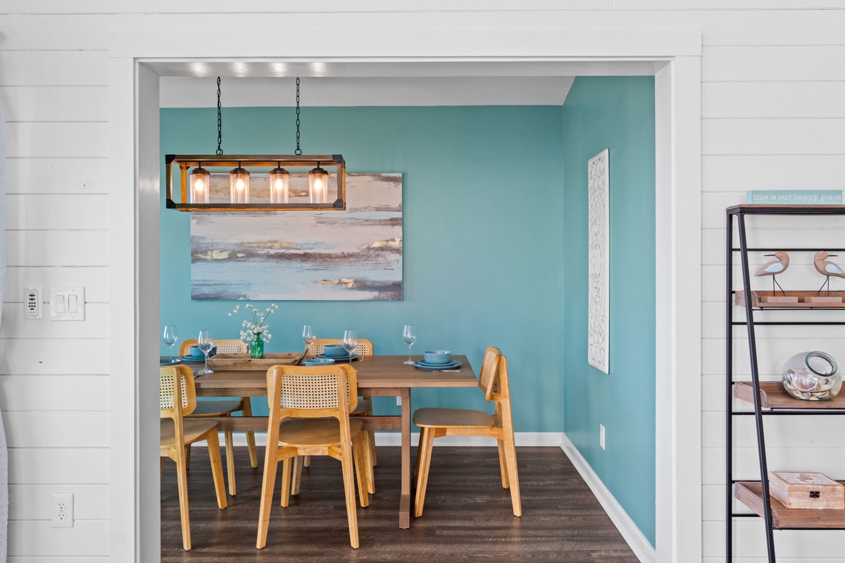 Step into your bright dining nook where turquoise walls and warm wood create the perfect spot for morning coffee or evening meals together.