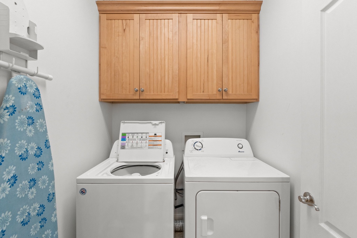 Your laundry room features a full-size washer and dryer with convenient upper cabinetry for storing essentials, making it easy to keep your vacation wardrobe fresh.