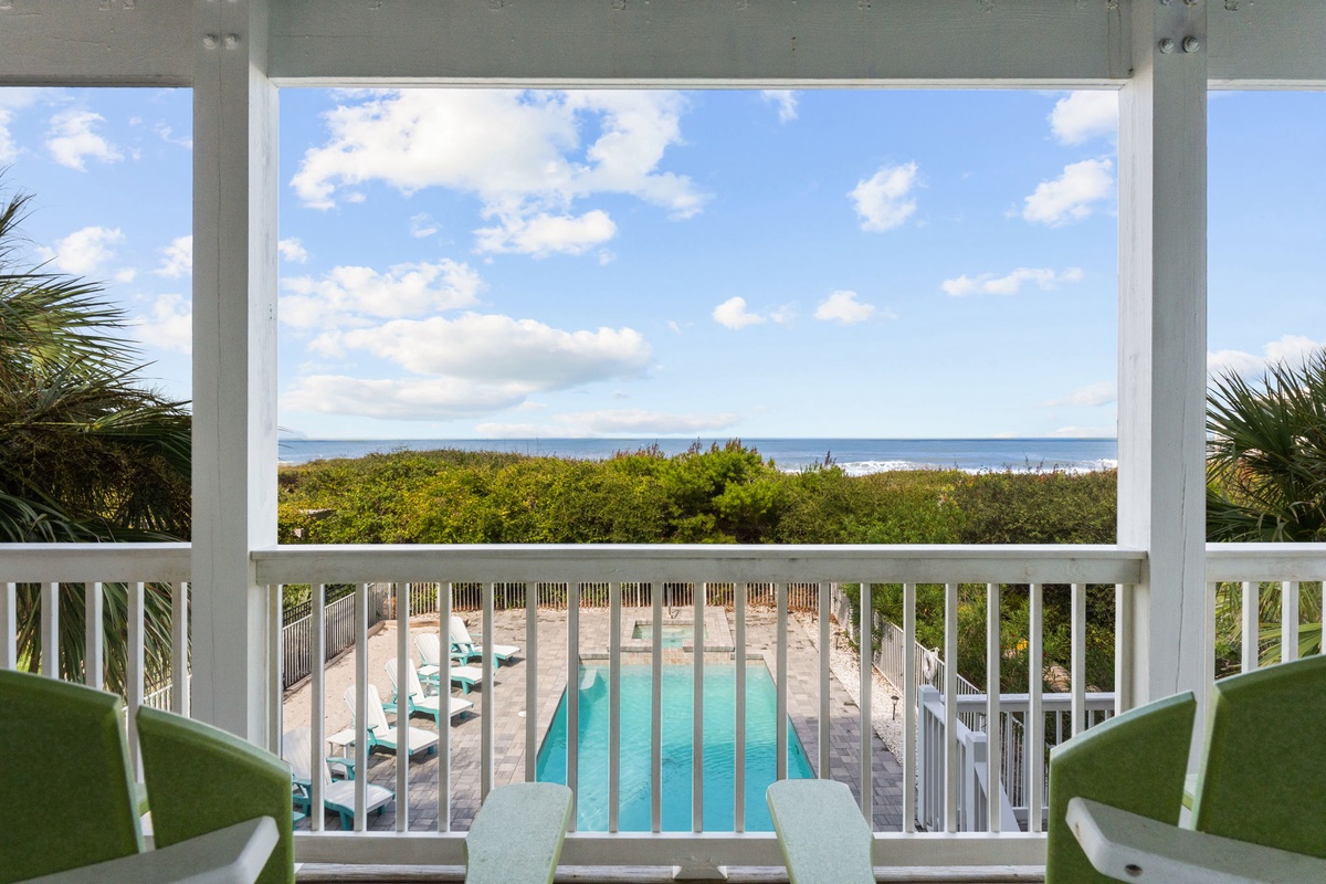 Step onto your private balcony and take in the stunning ocean view stretching to the horizon. Below, the sparkling pool awaits, surrounded by lush coastal greenery and soft sand.