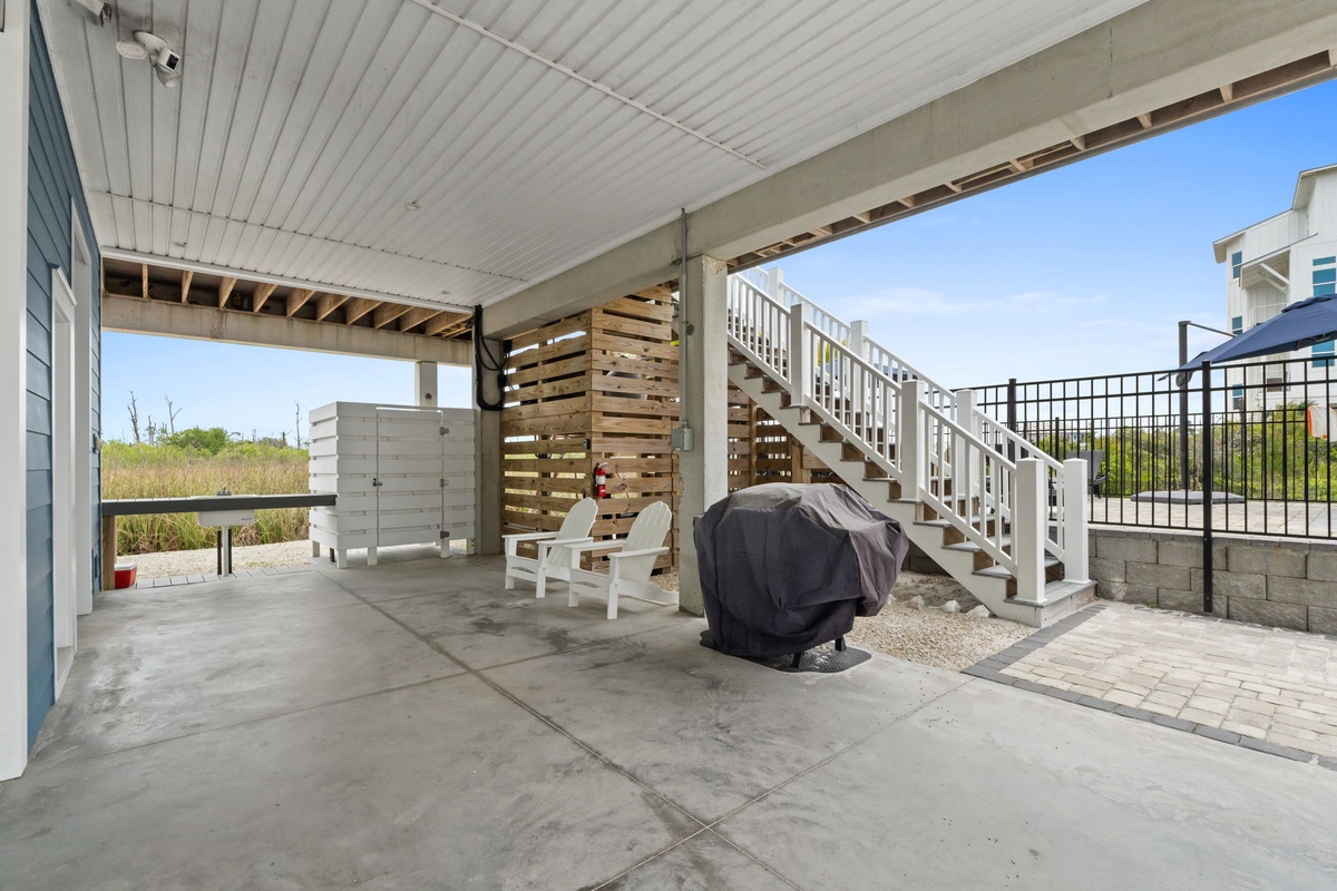 Relax on your private covered patio with seating and grill, perfect for outdoor dining and unwinding after beach days.