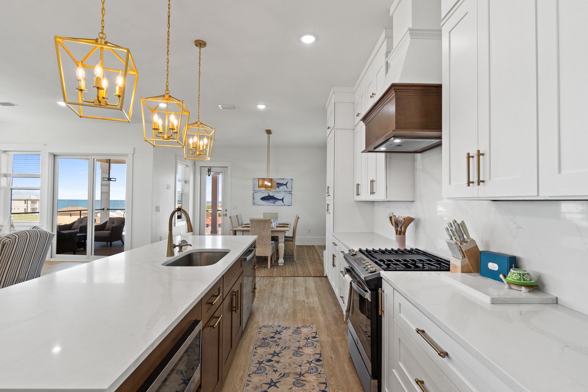 Cook with ocean views in this bright, modern kitchen featuring quartz countertops and premium appliances.