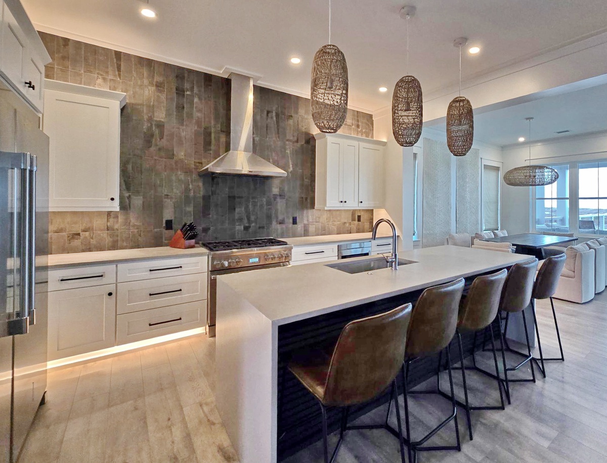 Your gourmet kitchen awaits with sleek island seating, premium appliances, and stunning pendant lighting for memorable cooking experiences.