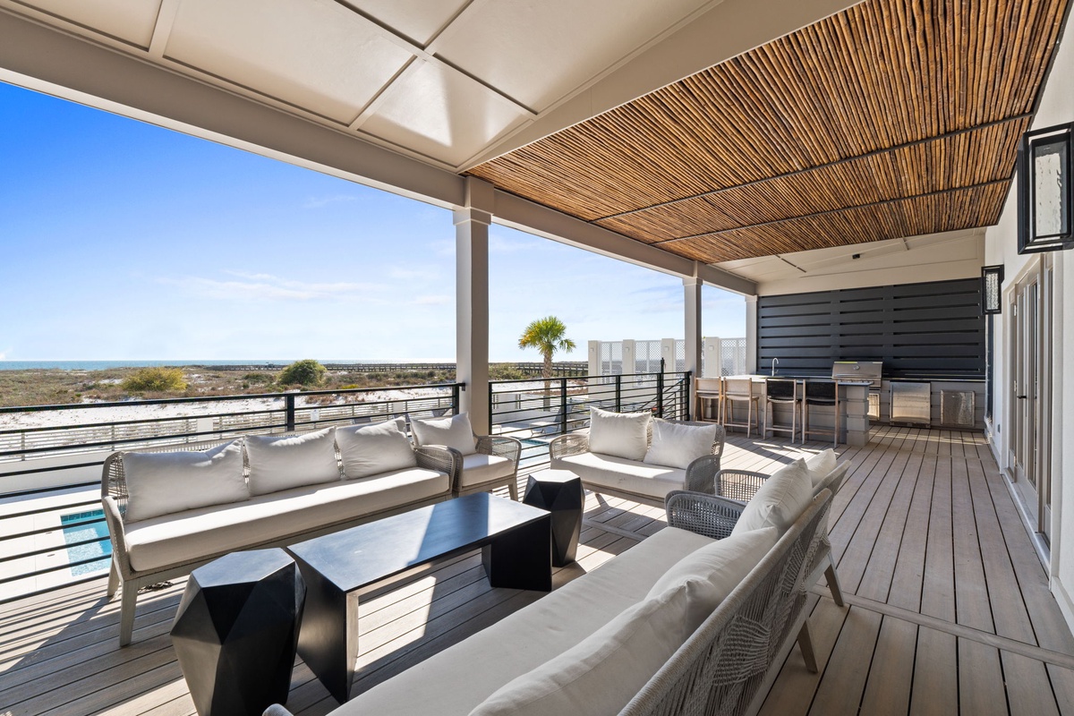 Your private terrace features plush seating and panoramic views, perfect for morning coffee or evening relaxation under the bamboo ceiling.