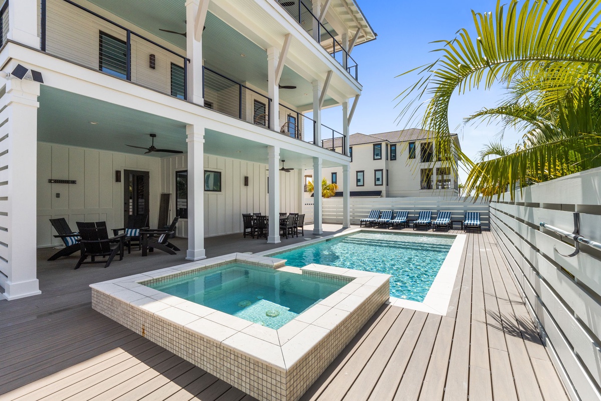 Soak up the sunshine in your private pool and hot tub, surrounded by breezy palms and stylish coastal architecture perfect for unwinding in style.
