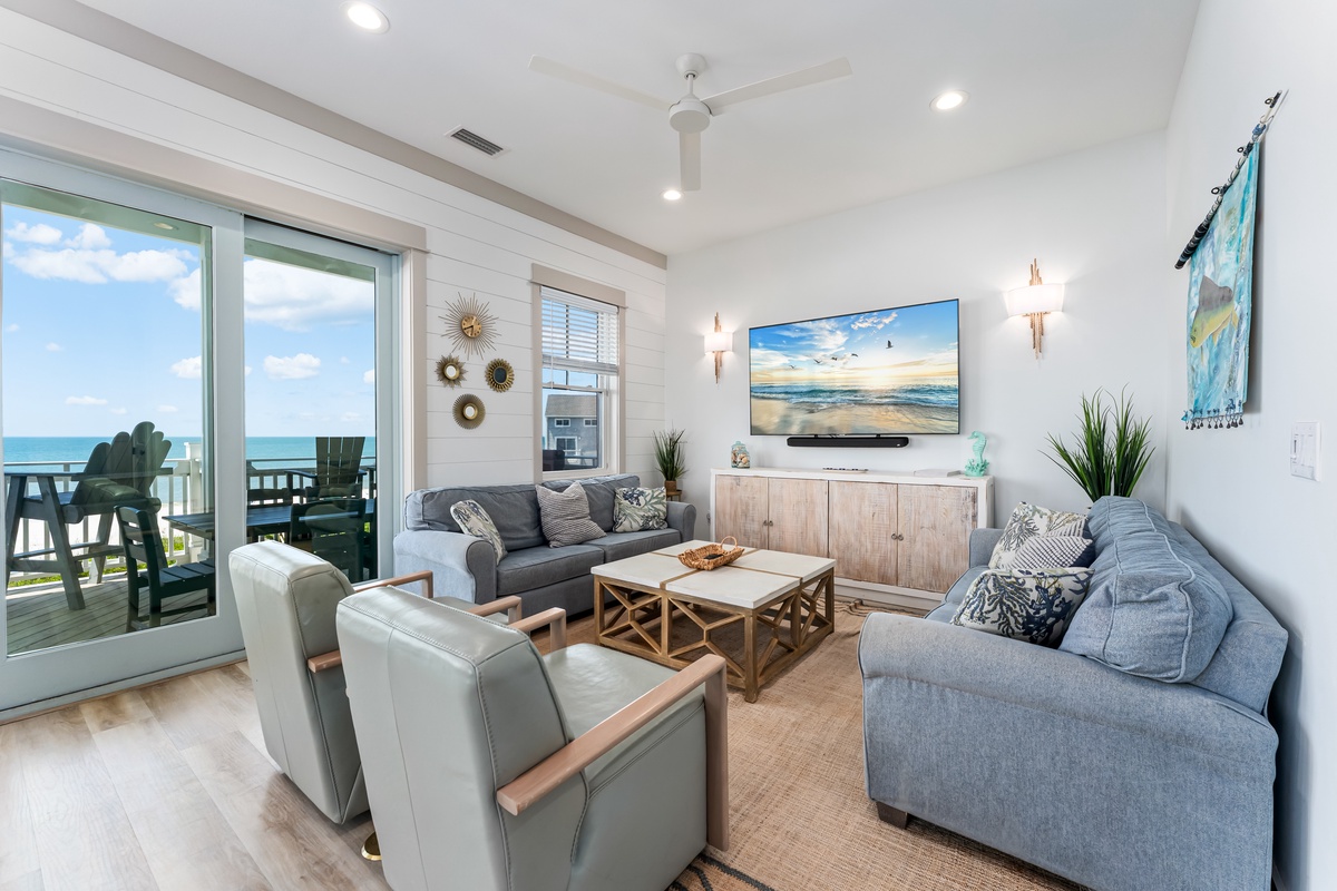 Relax in your coastal living room where ocean breezes flow through sliding doors to your private balcony with stunning sea views.