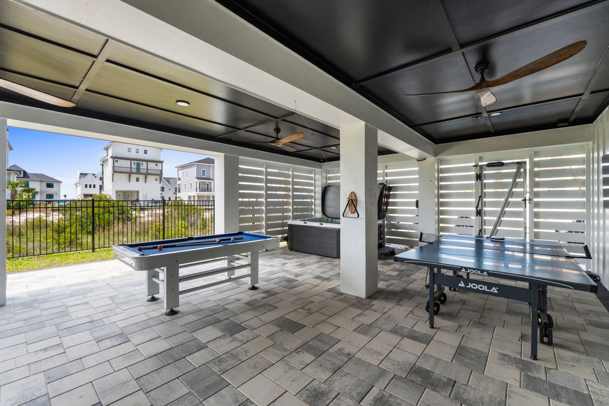 Covered outdoor game space with billiards, table tennis, and darts—perfect for friendly competition while enjoying your stay.