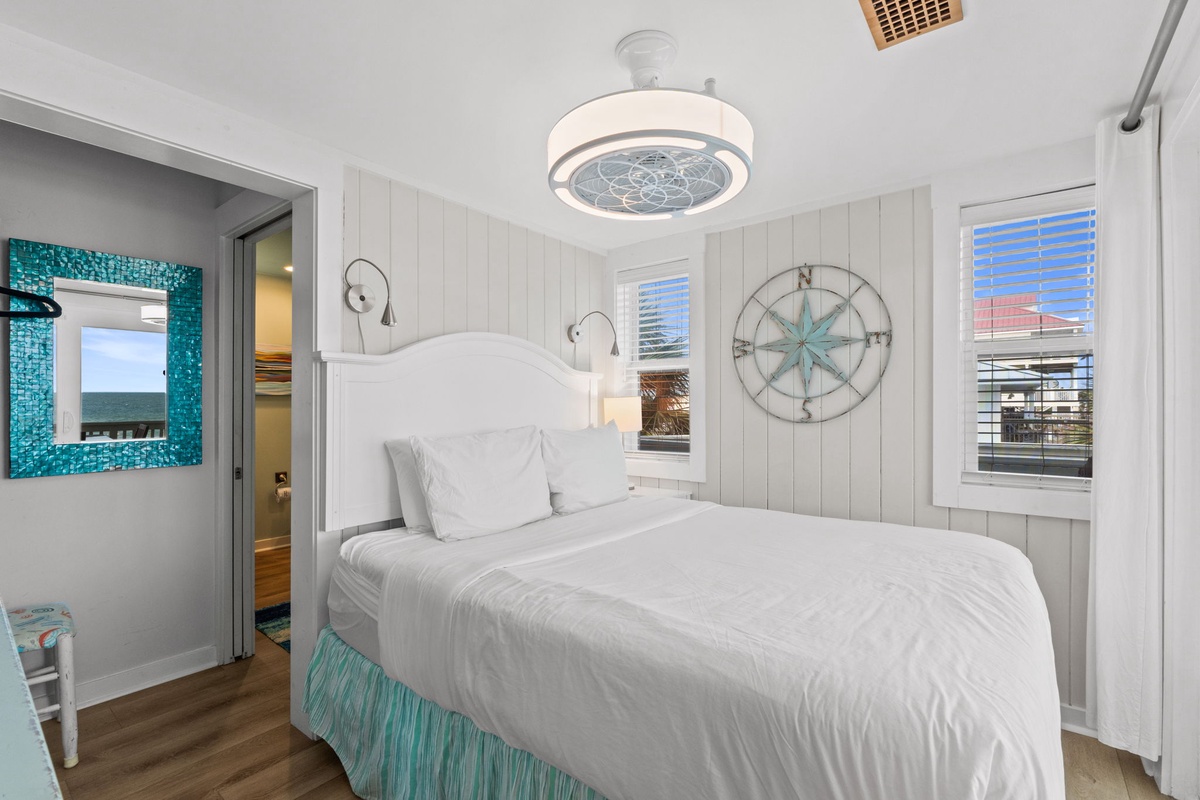 Drift off in this coastal-inspired bedroom where soothing white linens and charming nautical touches invite your most peaceful night's sleep.