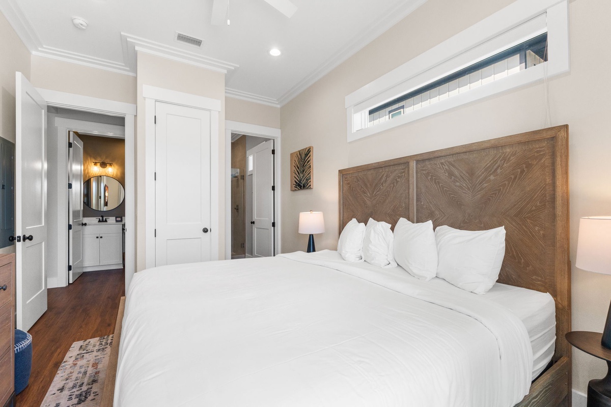 Sink into crisp white linens and enjoy your private ensuite with modern touches and natural light streaming through elegant windows.