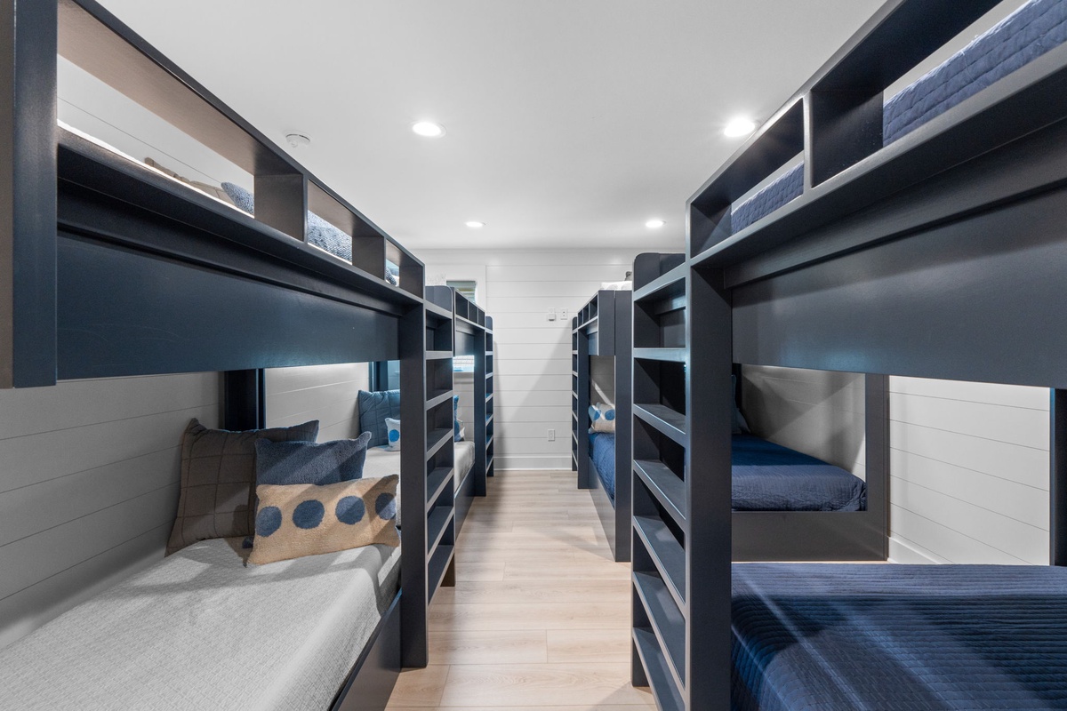 Your bunk room sleeps everyone comfortably with custom-built beds, personal storage, and stylish navy and white linens for the perfect group getaway.
