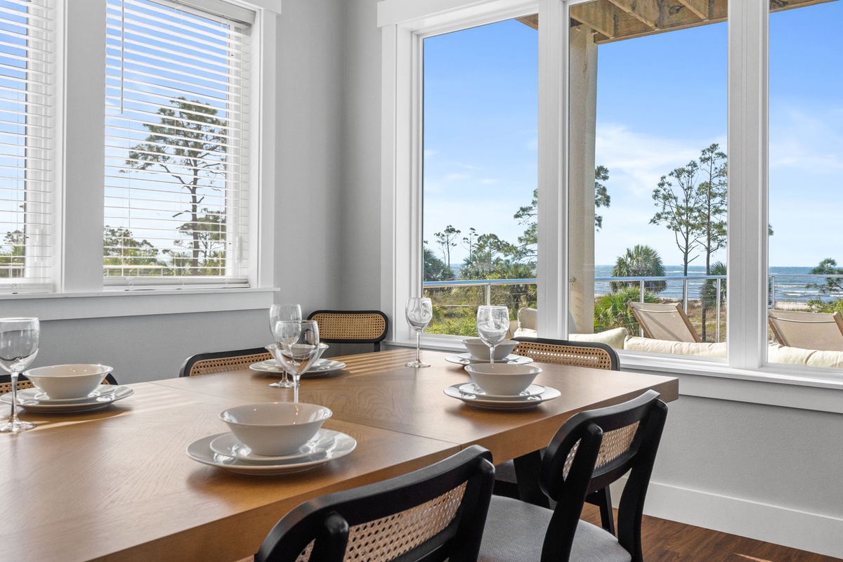 Your oceanfront dining table awaits, perfectly set for memorable meals while you soak in stunning sea views through floor-to-ceiling windows.