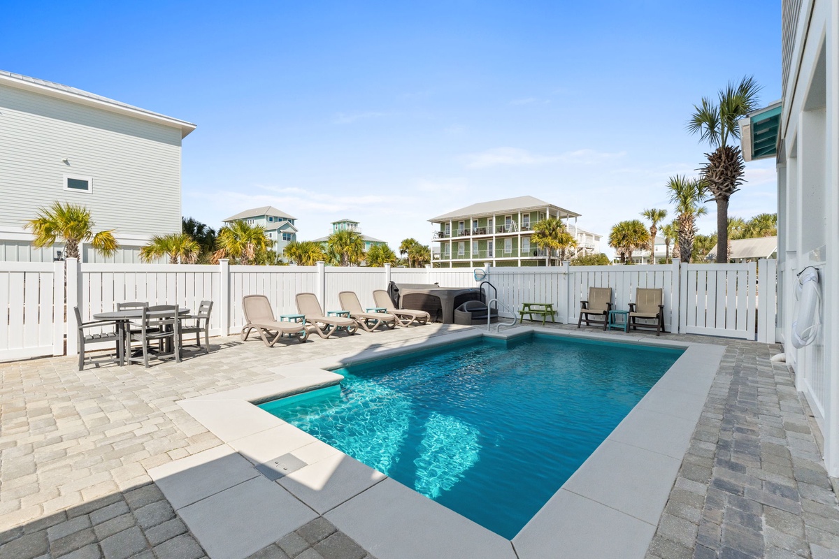 Dive into your private pool oasis, complete with loungers and dining space for perfect relaxation.