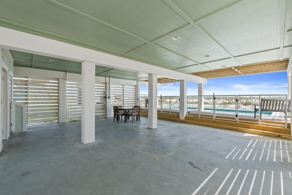 Spacious covered terrace with stunning water views, perfect for relaxing or dining outdoors in comfort and style.