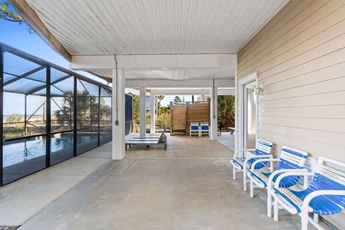 Relax in your covered poolside oasis with comfortable seating, perfect for unwinding after swimming laps or soaking up Florida sunshine.