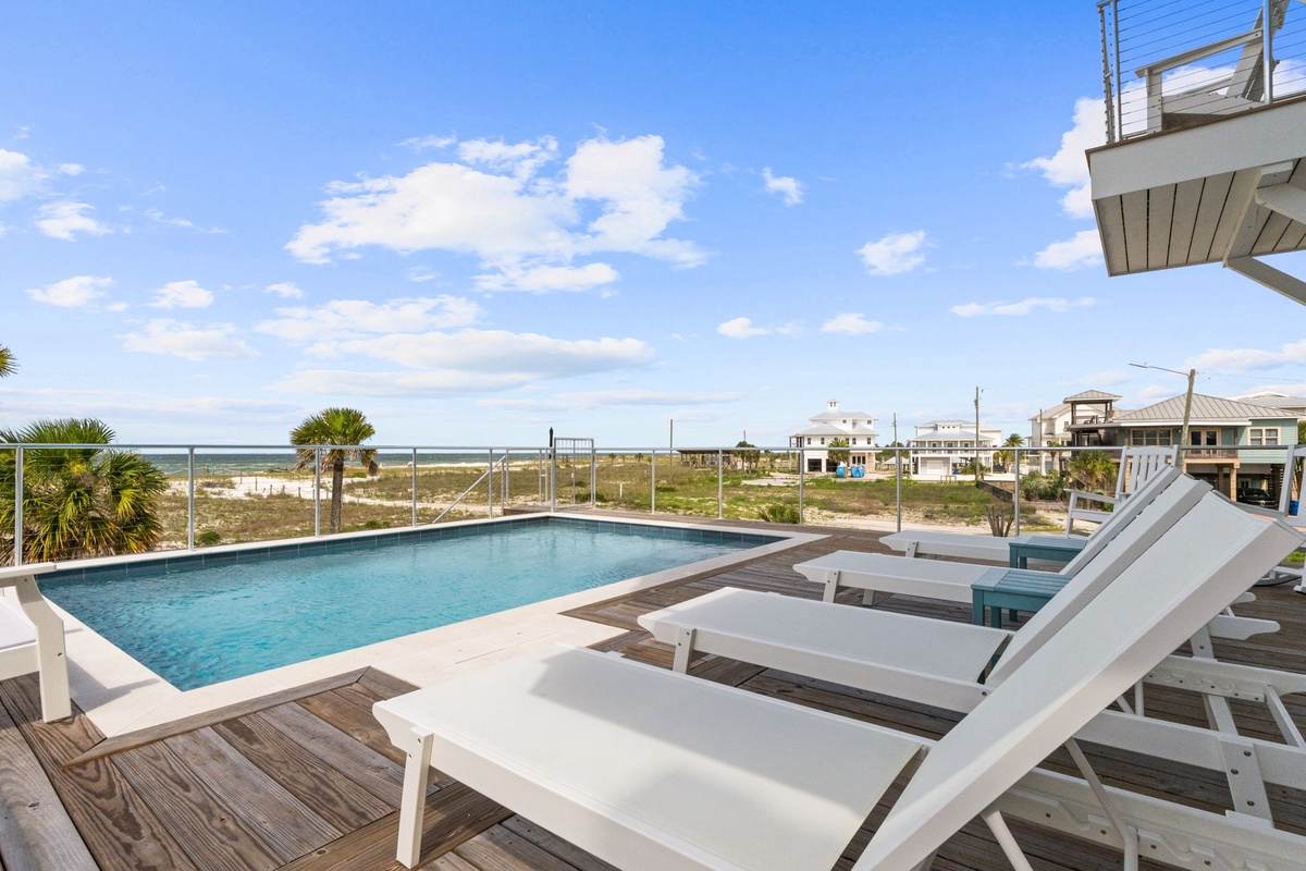 Soak up the sun on your private pool deck with lounge chairs and sweeping ocean views, perfect for lazy afternoons and coastal breezes.