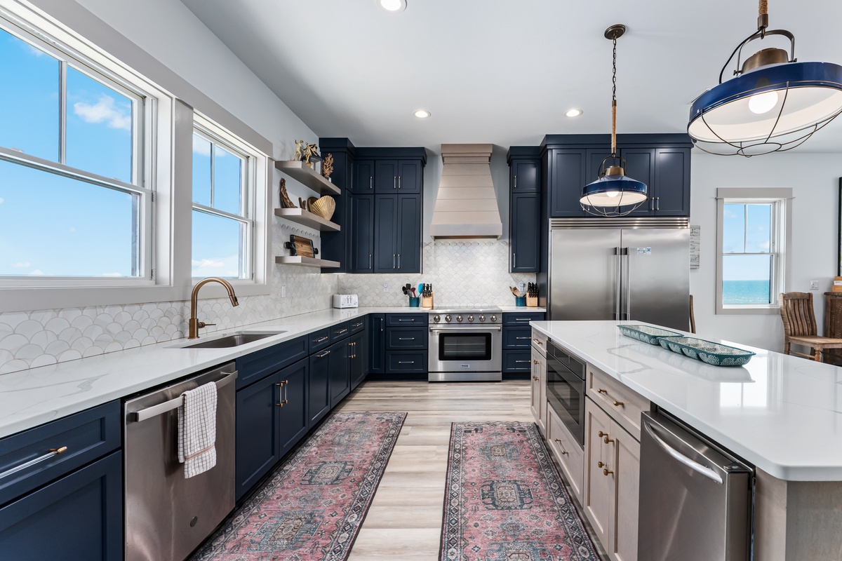 Your fully equipped gourmet kitchen awaits with gleaming countertops, premium appliances, and stunning ocean views for memorable meal preparation.