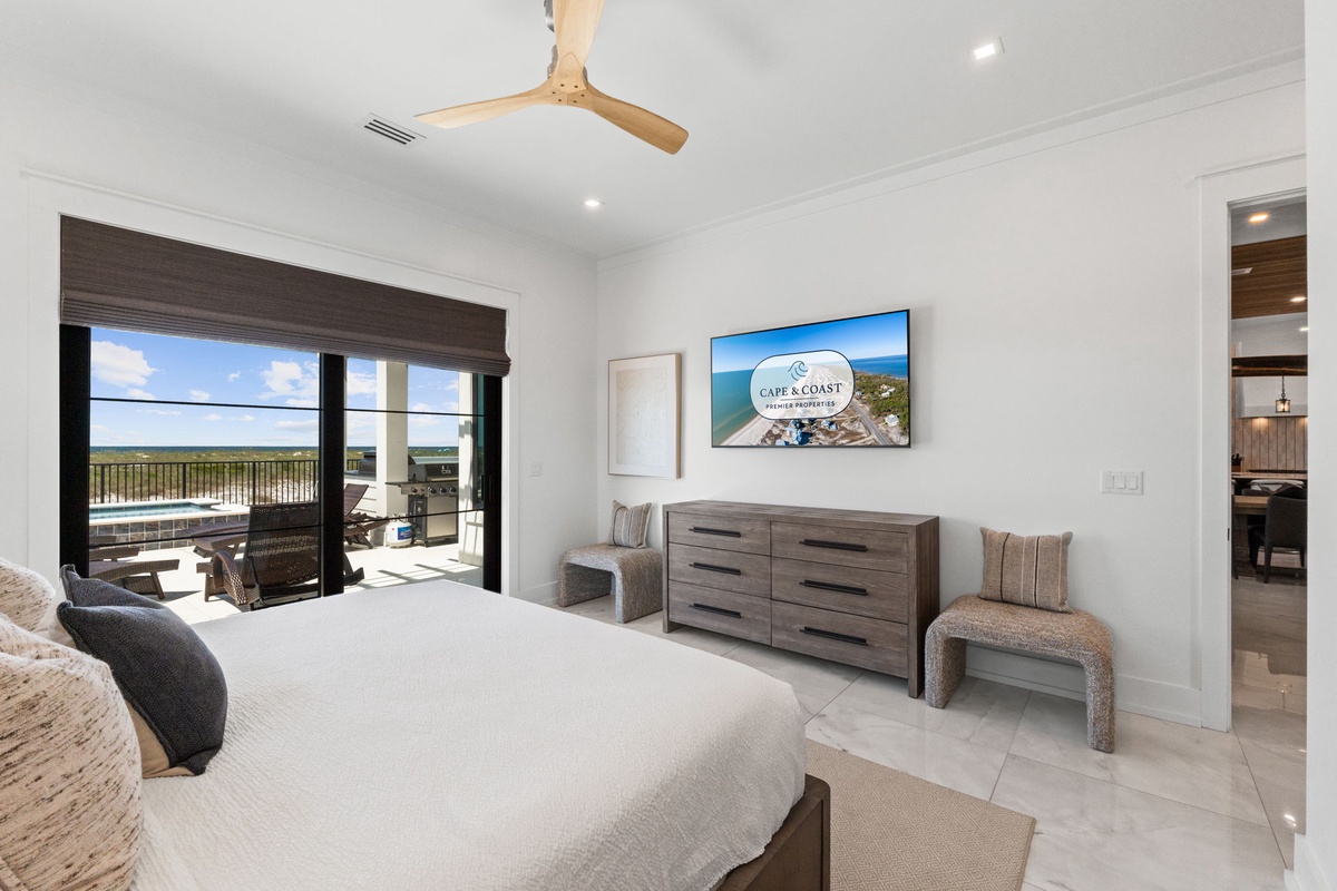 Wake up to serene water views framed by floor-to-ceiling windows, with warm natural light flooding your inviting bedroom retreat and a private balcony just steps away.