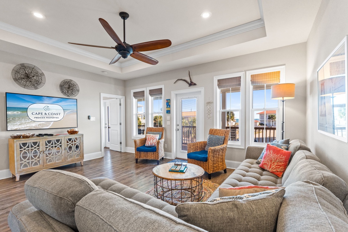 Relax in your stylish living room with plush seating, coastal decor, and French doors opening to your private balcony.