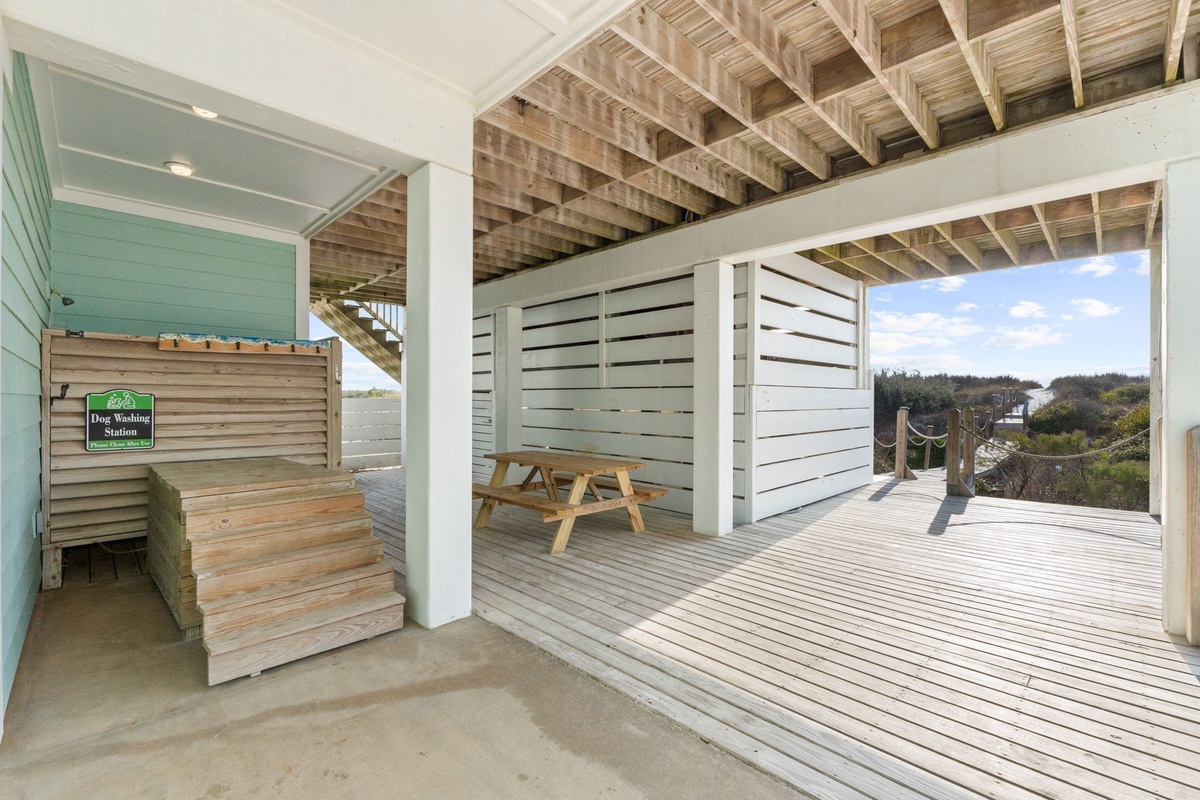 Relax on your private deck with stunning natural views, complete with outdoor dining and a convenient dog washing station for furry companions.