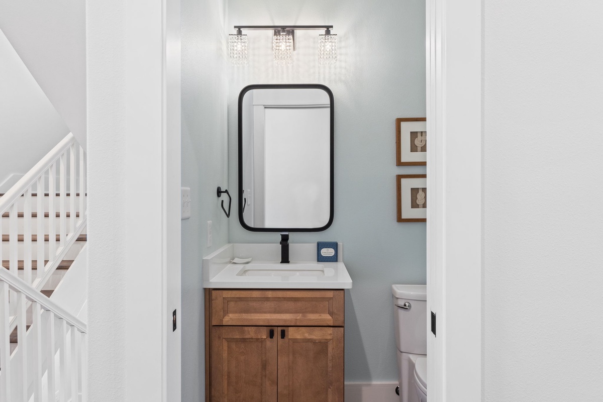 Step into your serene private bathroom, where coastal-inspired tones and elegant lighting create a peaceful retreat for you to unwind after exploring the area.
