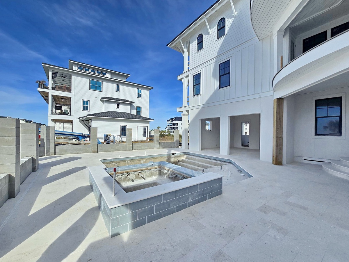 Modern beachfront property featuring elevated design and private hot tub area with stunning coastal architecture.