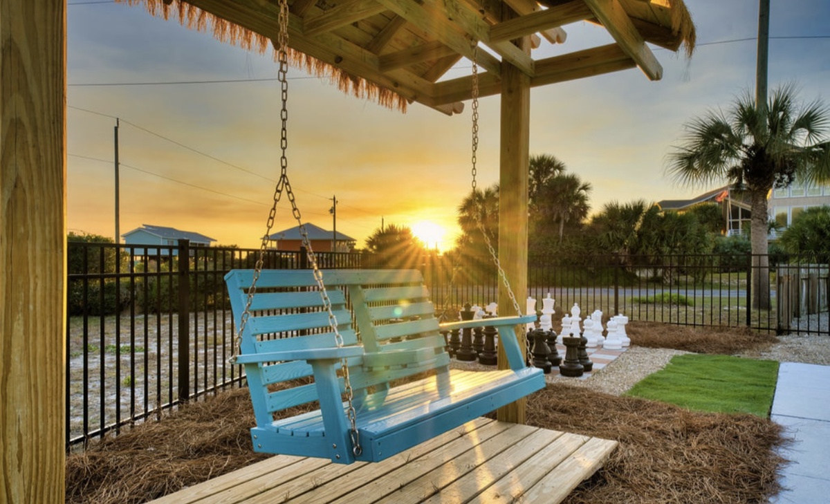 Sway on your private porch swing as golden sunlight filters through palm trees, creating the perfect spot for morning coffee or evening relaxation.