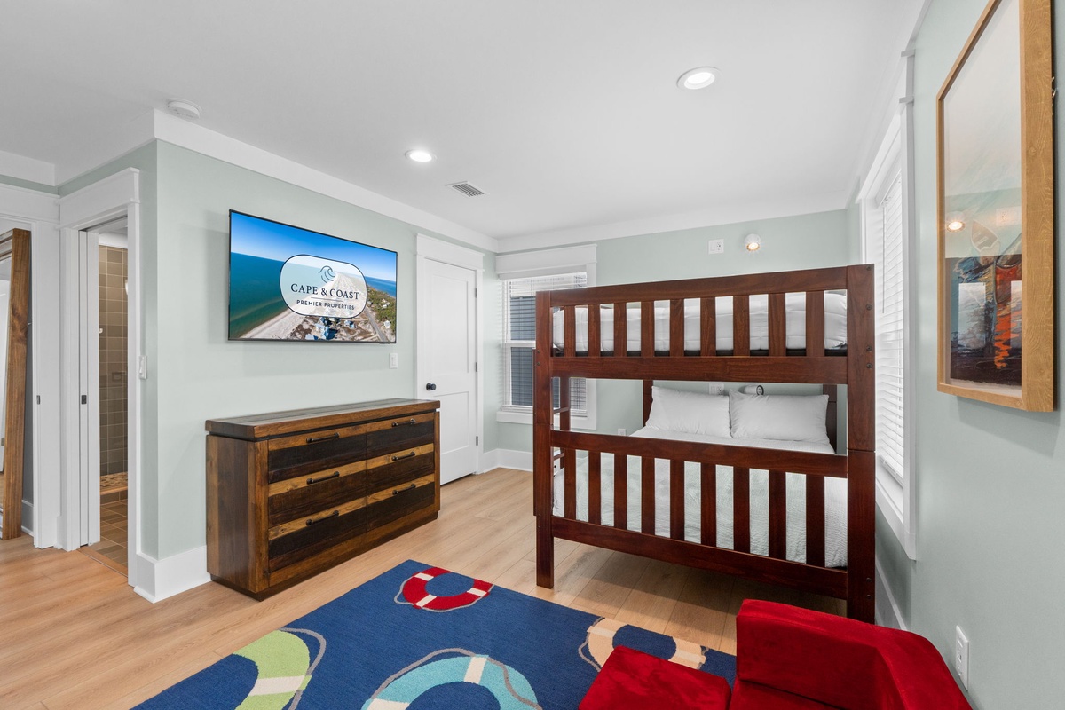Your kids will love this cheerful bedroom with its sturdy bunk beds, warm wood accents, and coastal vibe—perfect for creating vacation memories together.