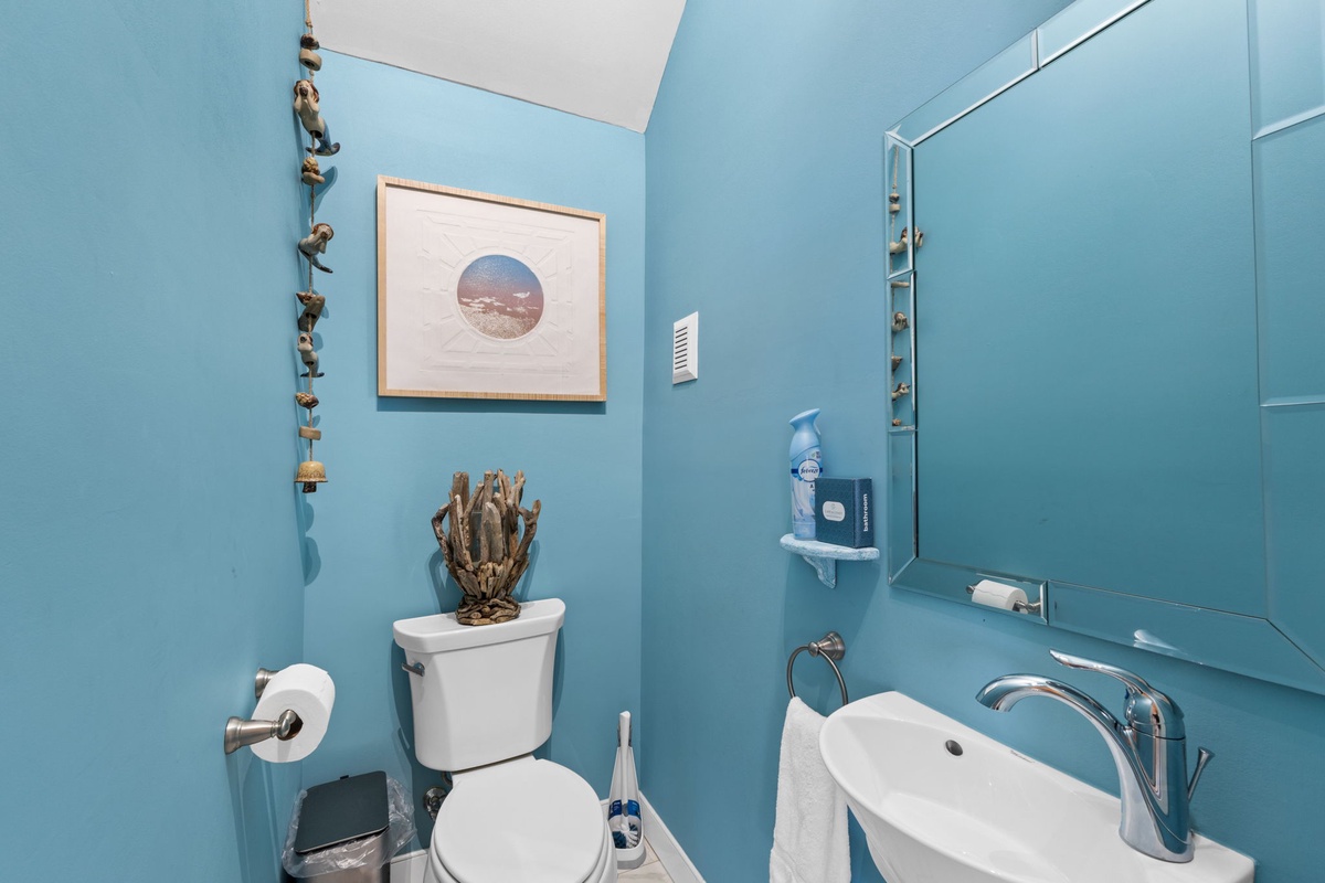 Refresh in your bright, coastal-inspired powder room with charming nautical touches and thoughtful amenities for your comfort.