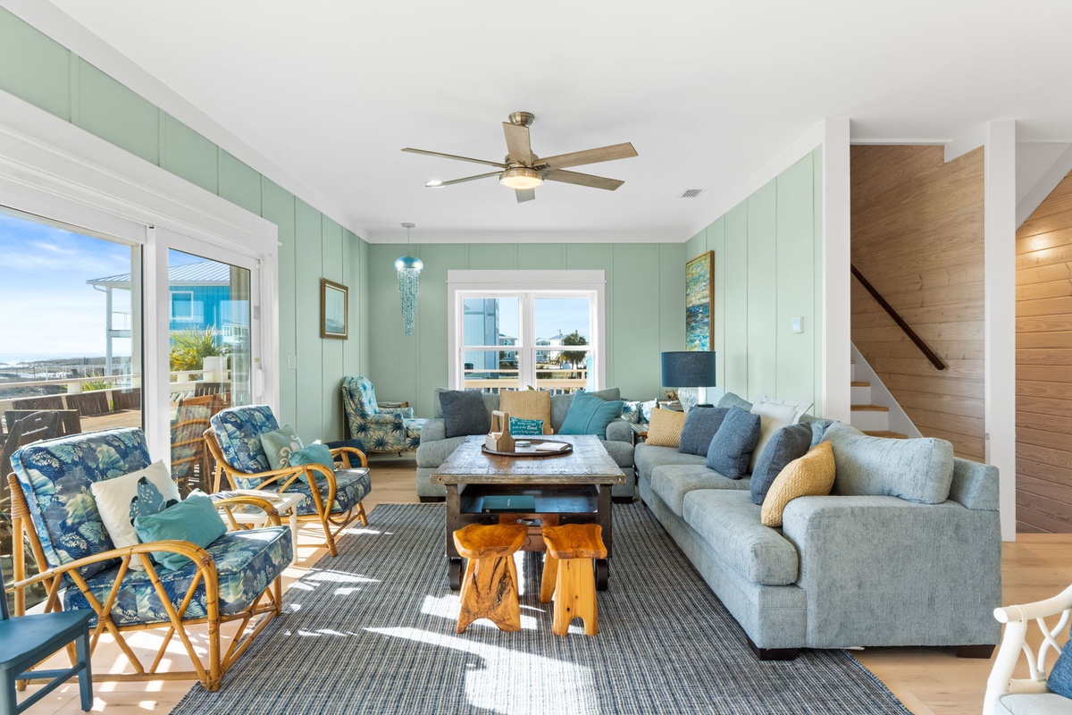 Relax in your coastal living room with ocean blues and natural textures creating the perfect beach house atmosphere.