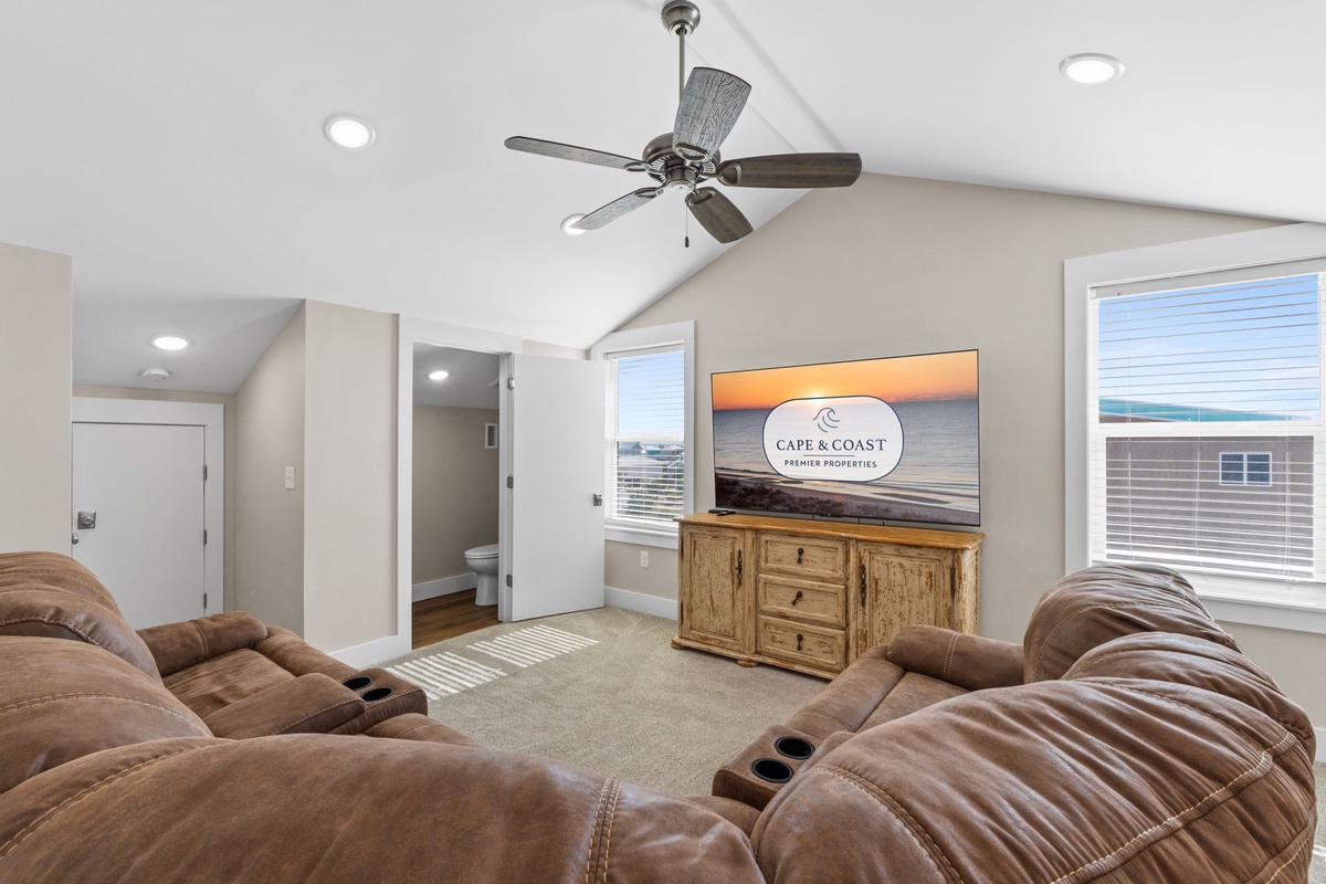 Relax in your spacious living room with plush recliners, vaulted ceilings, and large-screen entertainment for perfect movie nights.