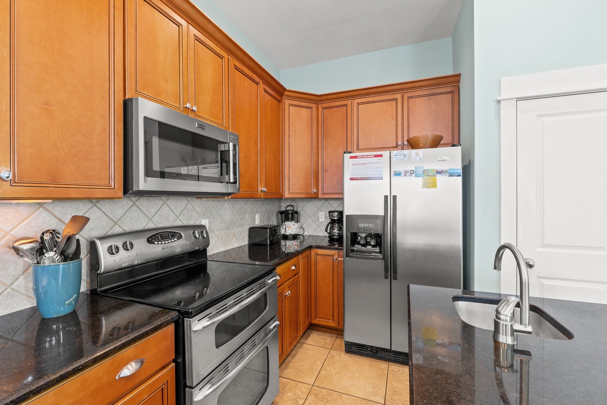 Your fully equipped kitchen features granite counters, stainless appliances, and warm wood cabinets—perfect for preparing your favorite vacation meals.