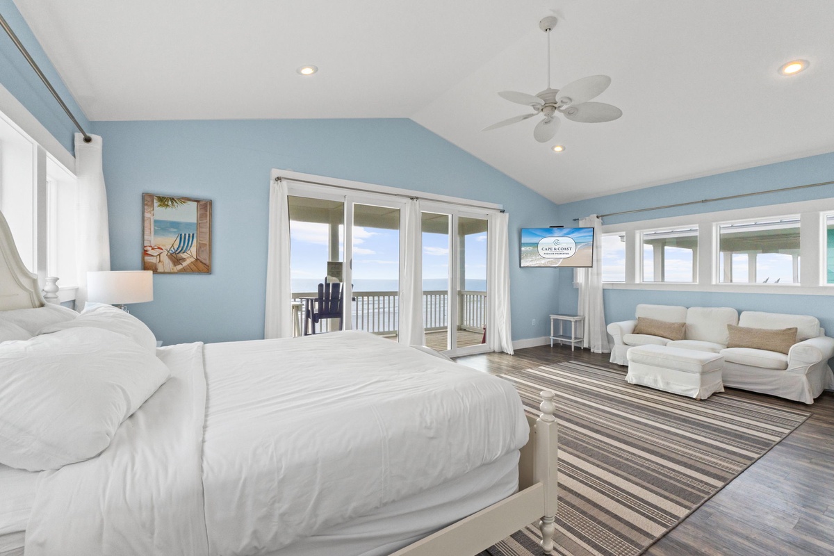 Wake up to ocean views from your spacious bedroom, where coastal blue walls and crisp white linens create your perfect seaside retreat.