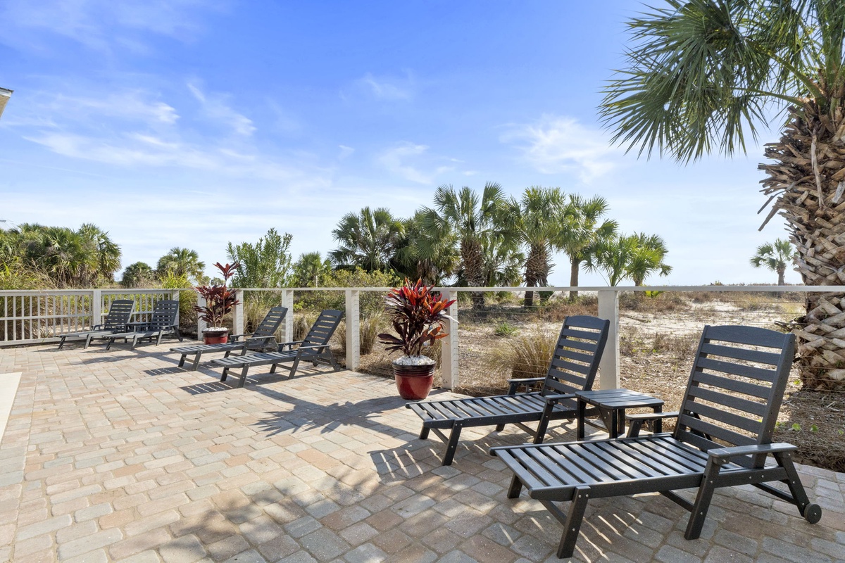 Bask in sunshine on your private patio, complete with comfortable loungers and tropical palm views for the perfect beach getaway retreat.