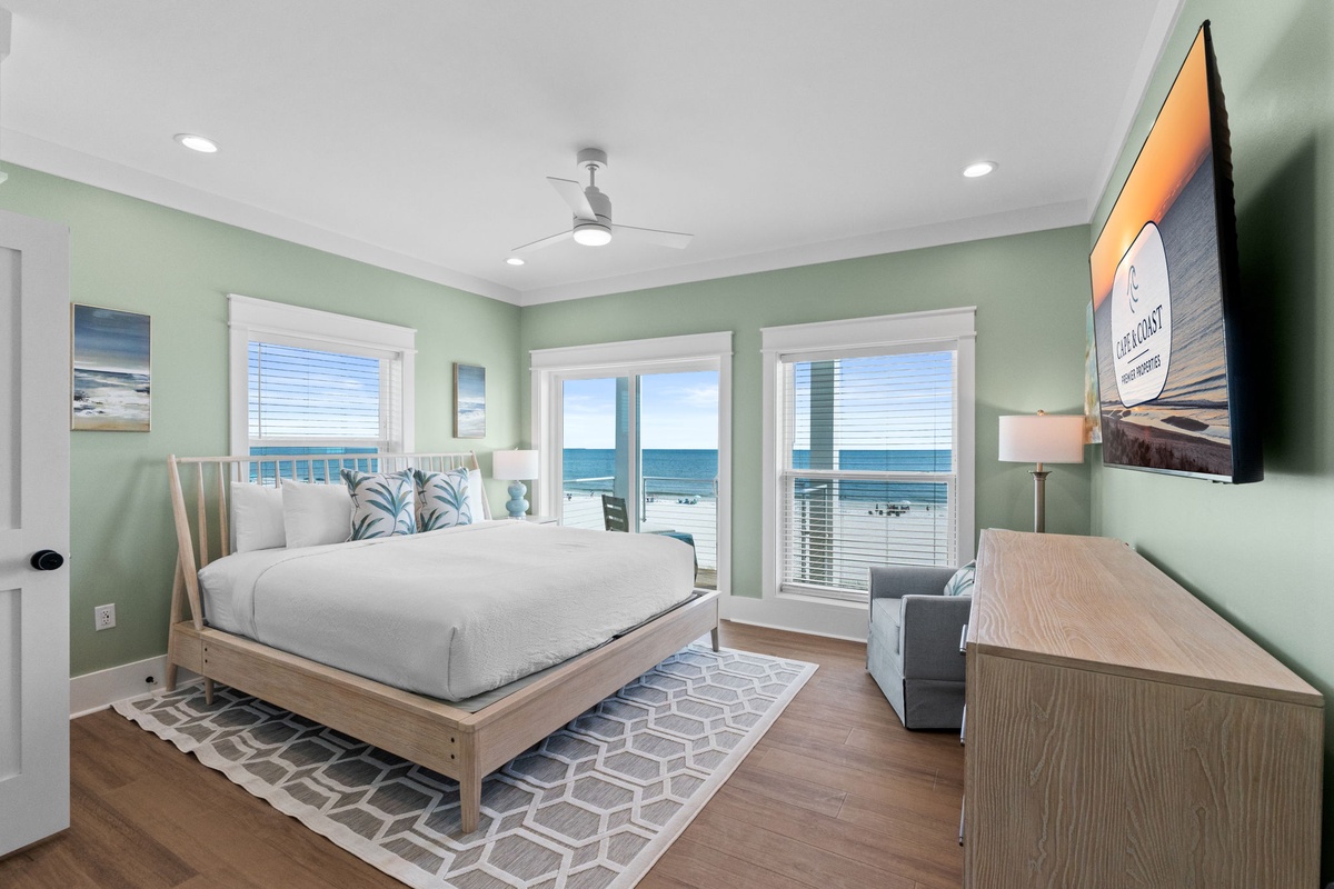 Wake up to stunning ocean views from your serene bedroom retreat, where gentle sea breezes flow through balcony doors and soft coastal hues invite restful mornings by the beach.