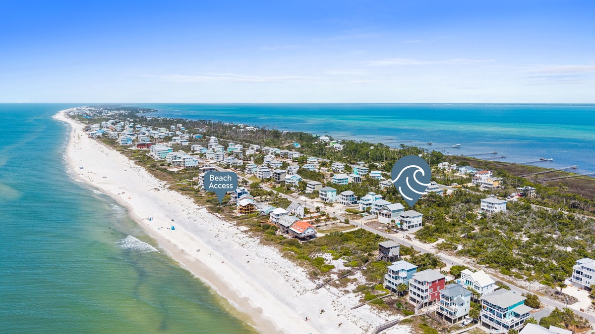 Stunning coastal community with pristine white sand beaches and crystal-clear turquoise waters stretching to the horizon.