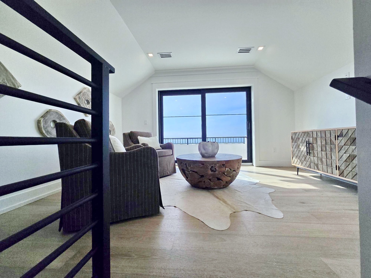 Relax in your stunning sea-view lounge with contemporary furnishings and breathtaking ocean panoramas through floor-to-ceiling windows.