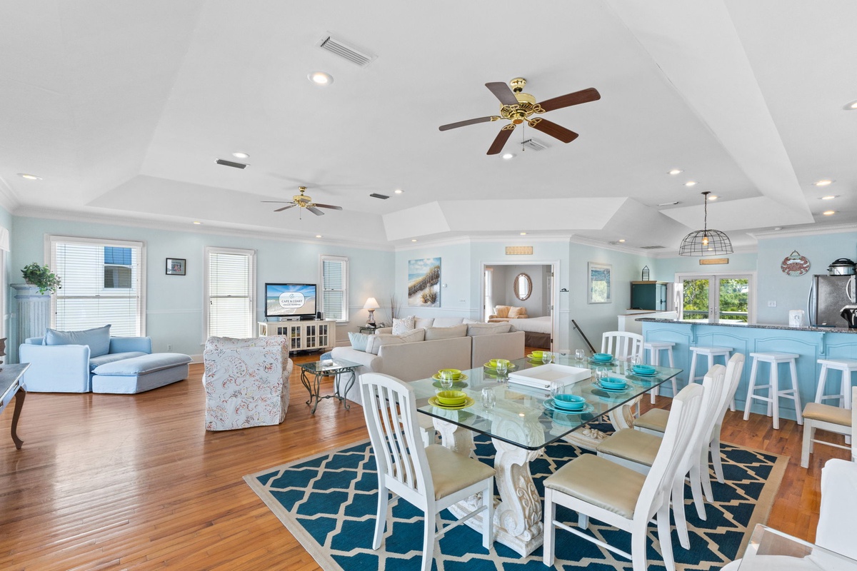 Spacious coastal-inspired living where you'll gather around the glass dining table and unwind in the airy living room.