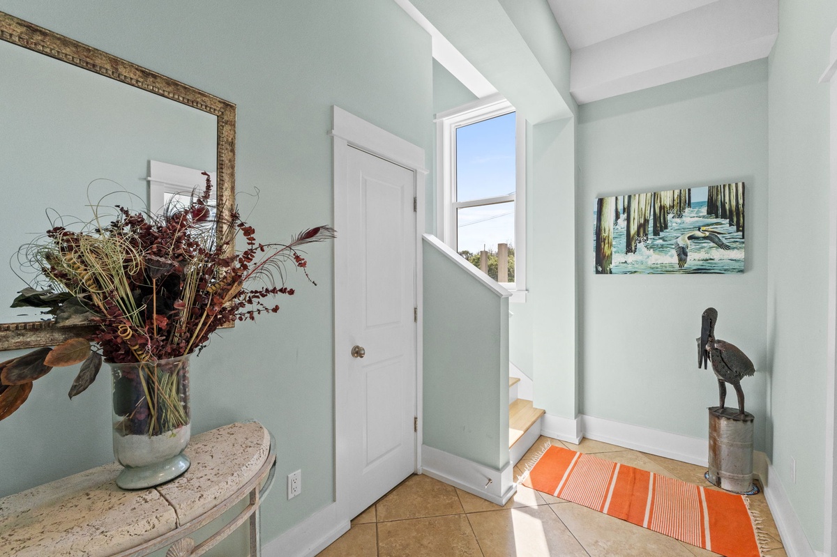 Step into your bright, welcoming entryway with soothing coastal colors and charming nautical touches that instantly make you feel at home.