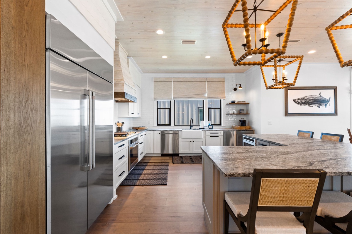 Your gourmet kitchen awaits with granite counters, stainless appliances, and coastal charm—perfect for creating memorable meals together.
