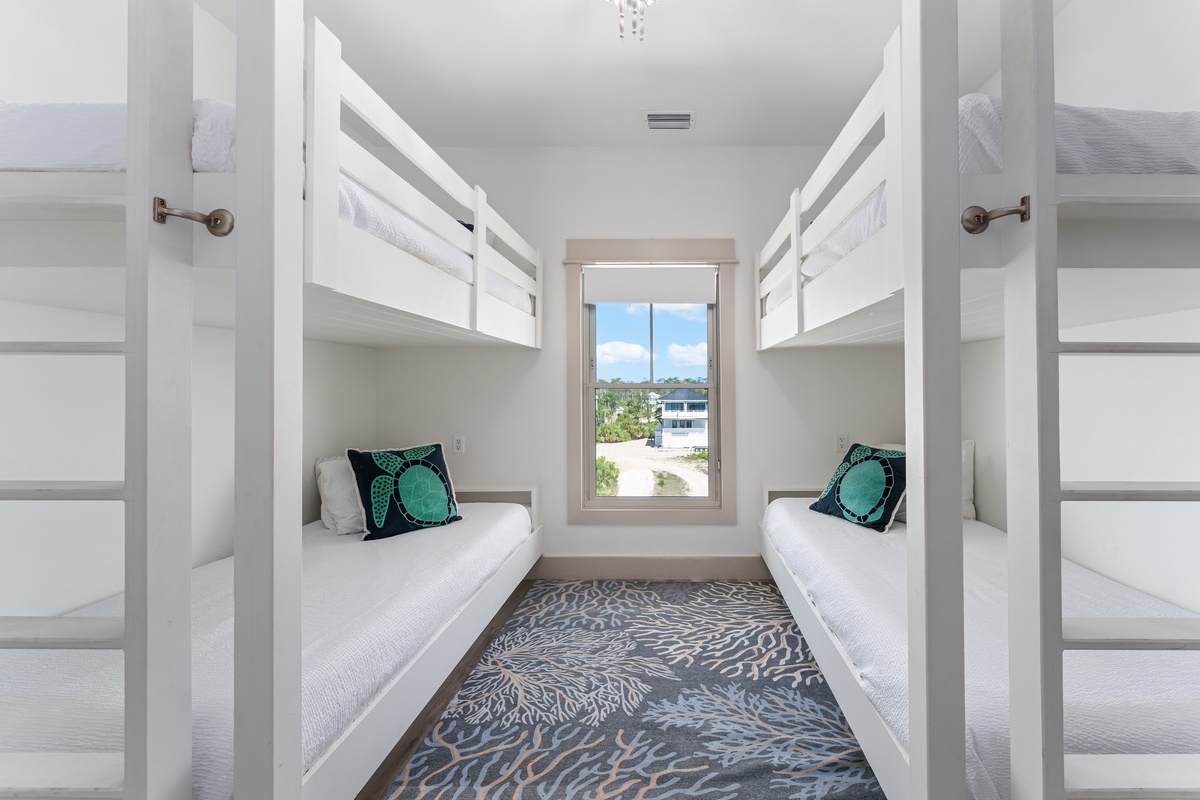 Your kids will love these custom bunk beds with crisp linens and colorful accents, creating the perfect shared adventure space.