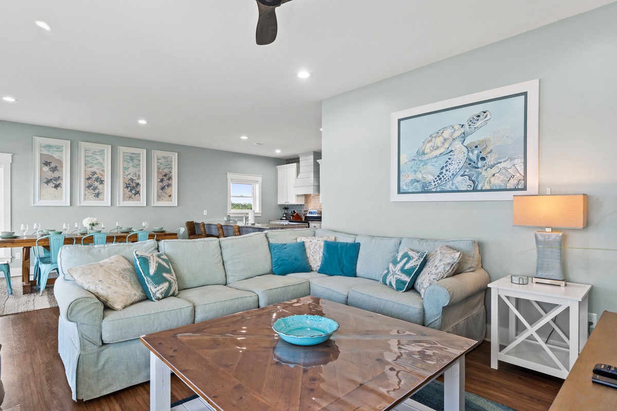 Settle into your coastal-themed living room, where soft sea glass tones and ocean-inspired artwork create a calming retreat perfect for your relaxation.